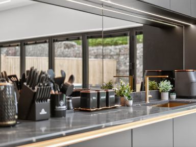 A kitchen with a sink and utensils at Ty Uchel