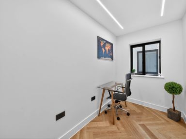 A home office with a desk, chair, and map at Ty Uchel