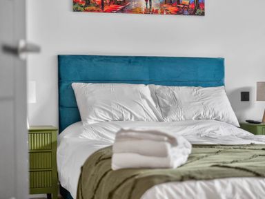 A bedroom with a bed and bedside tables at Ty Uchel