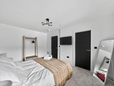 A bedroom with a bed and a mirror at Ty Uchel