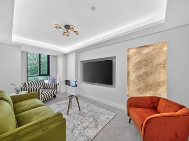 A living room with sofas and a television at Ty Uchel