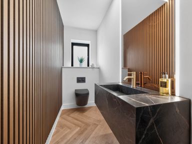 A bathroom featuring a sink and toilet at Ty Uchel