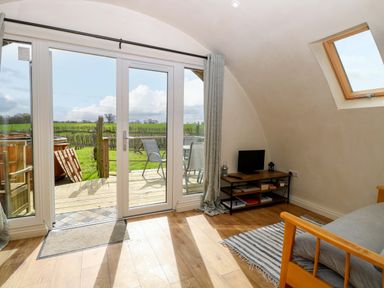 A living room with a view of the outdoors at Grape Escape near Halesworth