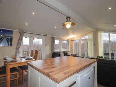 A living room with a dining table and chairs at Monach 1 