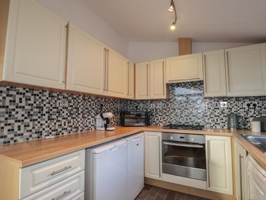 A kitchen with cabinets and appliances at Colonsay