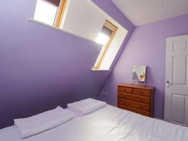 A bedroom with bed and mirror at Lady Of Lourdes Whitchurch, Herefordshire