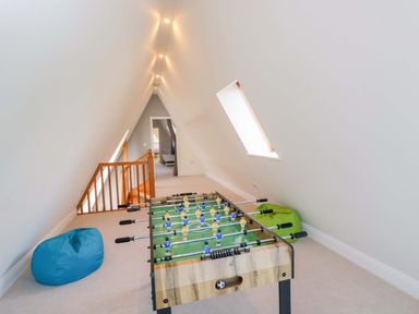 A games room with a foosball table and bean bags at Lady Of Lourdes in Whitchurch, Herefordshire