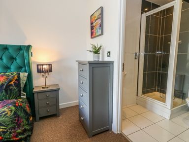 A bedroom with a bed and shower cubicle at Rodwell Holt in Weymouth