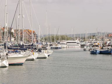 A marina filled with sailboats and yachts at Rodwell Holt in Weymouth