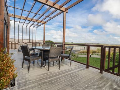 An outdoor seating area with a table and chairs at Adelaide in Redruth