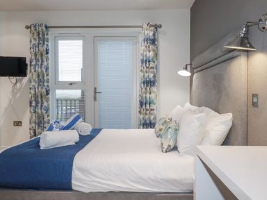 A bedroom with a bed and window at Adelaide in Portreath