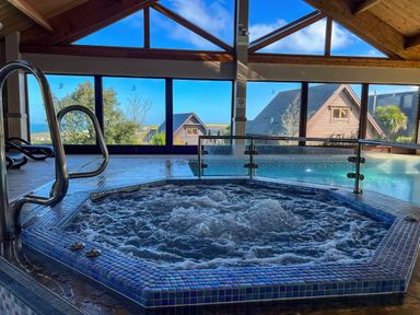 A hot tub with a view of the ocean at Adelaide in Portreath