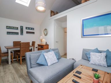 A living room with a table and chairs at Cove Retreat in Penzance