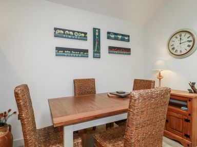 A dining room with a table and chairs at Cove Retreat in Penzance