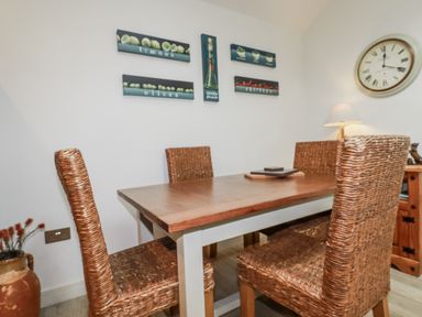 A dining room with a table and chairs at Cove Retreat in Penzance