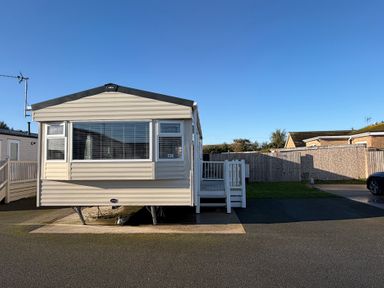 A caravan with a deck at The Beachside Hideout - St Michaels Caravan Park Towyn