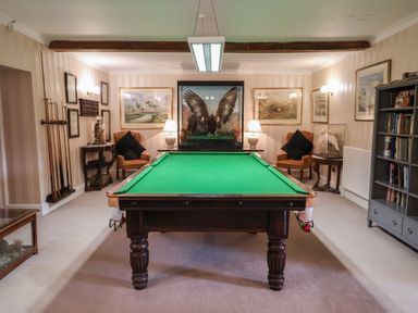 A snug with a pool table and seating at Winston Lodge in Beccles