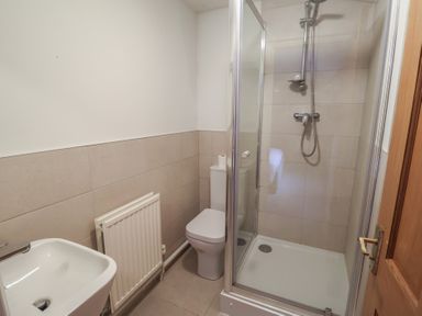 A bathroom with a shower and toilet at Winston Lodge in Beccles