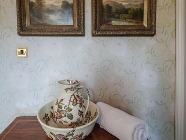 A pitcher and bowl with a towel at Winston Lodge in Beccles
