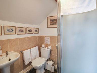 A bathroom with a sink, toilet, and shower at Winston Lodge in Beccles