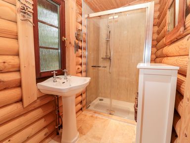 A bathroom with a shower and sink at Little Bears Hideaway @ 23 Lakeside, Felmoor Park near Felton