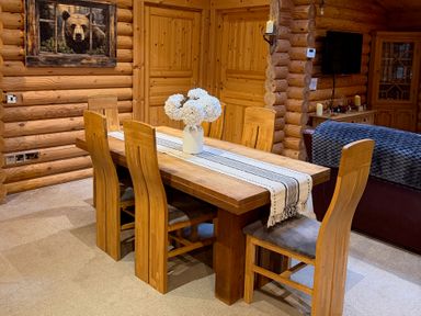 A dining room with a table and chairs at Little Bears Hideaway @ 23 Lakeside Felmoor Park near Felton