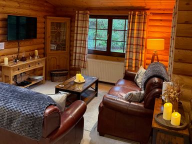 A living room with a sofa and coffee table at Little Bears Hideaway @ 23 Lakeside Felmoor Park near Felton