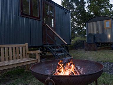 An outdoor area with a fire pit and a bench at No 1 The Orchard Upton Warren