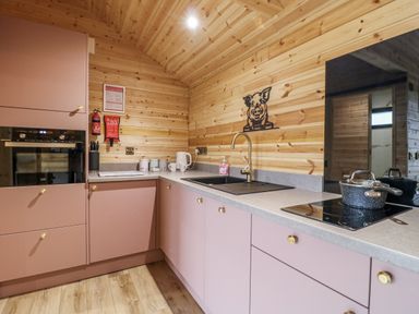 A kitchen with cabinets and sink at The Sty in Hatton, Derbyshire