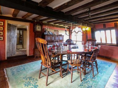 A dining room with a wooden table and chairs at Town Farm