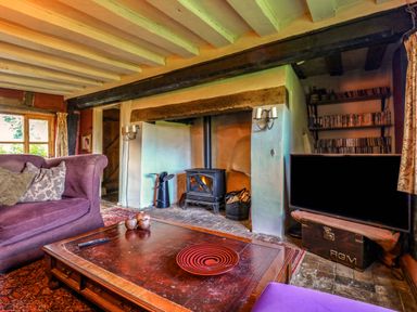 A living room with a fireplace and sofa at Town Farm