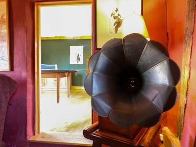A gramophone in a living room with a doorway leading to another room at Town Farm in 