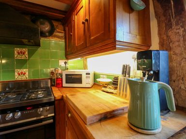 A kitchen with a stove, microwave, and kettle at Town Farm in 