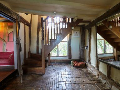 An entrance hall with staircase and brick floor at Town Farm 