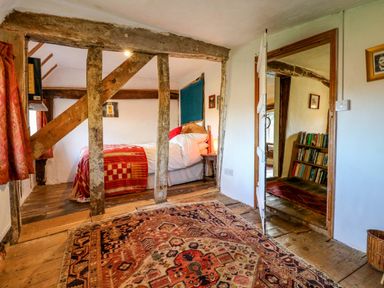 A bedroom with a rug and bookshelf at Town Farm in 