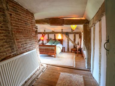 A bedroom with a bed and nightstand at Town Farm 