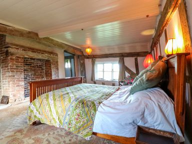 A bedroom with a bed and lamp at Town Farm in 