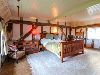A bedroom with a bed and armchair at Town Farm