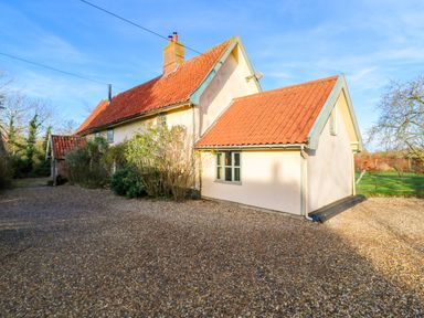 A house with a gravel driveway and trees at Town Farm in 