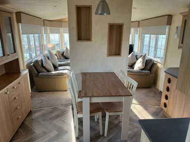 A dining area with a table and chairs at Gainc Bach Abergele