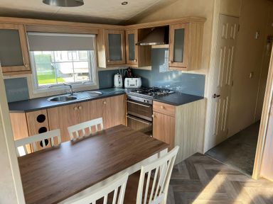 A kitchen with a stove and sink at Gainc Bach in Abergele