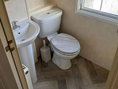 A bathroom with a toilet and sink at Gainc Bach in Abergele