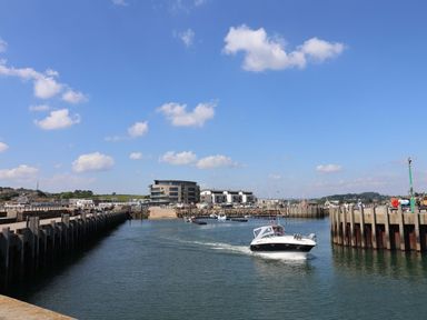 A view of a marina with boats and buildings at Rope Cottage in Bridport