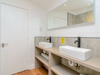 A bathroom with two sinks and a mirror at The Elton in Kings Cliffe