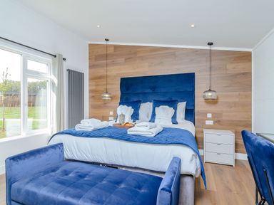 A bedroom with a bed and bedside table at The Elton in Kings Cliffe