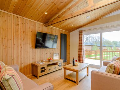 A living room with a television and coffee table at The Sutton (Pet) in Kings Cliffe