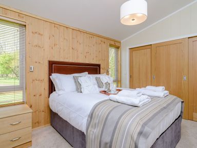 A bedroom with a bed and bedside table at The Chesterton in Kings Cliffe