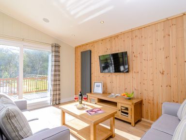 A living room with a sofa and television at The Chesterton in Kings Cliffe