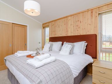 A bedroom with a double bed and a bedside table at The Chesterton (Pet) in Kings Cliffe