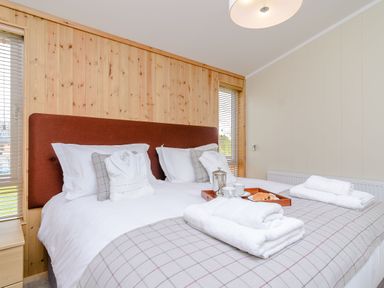 A bedroom with a bed and breakfast items on a tray at The Chesterton (Pet) Kings Cliffe